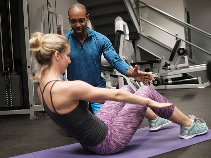 Personal trainer working with a client